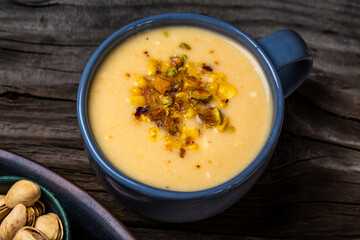 Corn Soup, Vegan cuisine. Traditional autumn corn soup. Served with corn, pistachios. Restaurant menu, dieting, cookbook recipe, top view