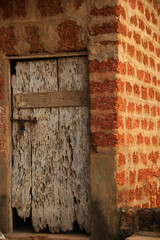 Old wooden door in holes. Door wounded by worms