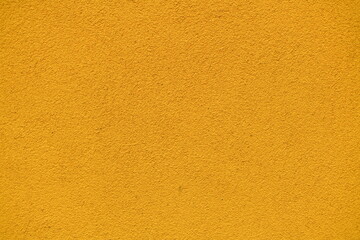 Pomarańczowa, żółta ściana z malowanego betonu