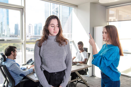 A Brunette Unhappy Woman Is Exposed To Discrimination And Harrassment In A Modern Office From The Woman Director N Front Of Their Colleagues.