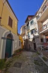 Fototapeta na wymiar A narrow street among the old houses of Castellabate, a medieval village in the Campania region, Italy. 