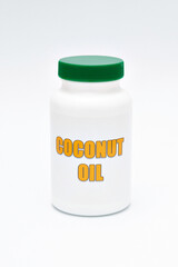 Health care - Nutritional supplement - Bottle of Coconut Oil. Isolated on a white background. Vertical shot.
