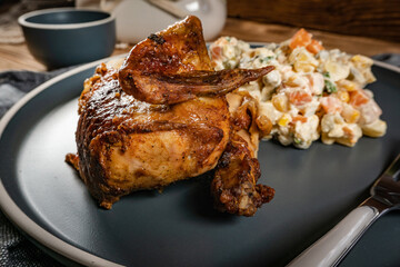 Roast chicken served with russian traditional salad.