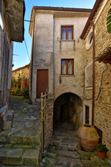 Fototapeta premium A narrow street among the old houses of Castellabate, a medieval village in the Campania region, Italy. 