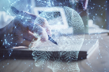 Obraz premium Multi exposure of writing hand on background with brain hologram. Concept of self learning.