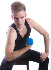 Young sportsman making exercises with dumbbels studio portrait on white background.