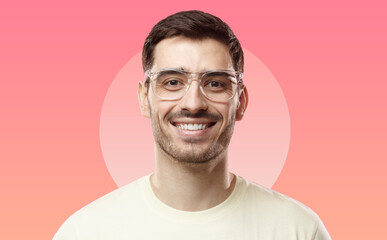 Close-up portrait of young man wearing beige t-shirt and trendy transparent glasses, looking at camera with happy smile. Eyewear ads concept