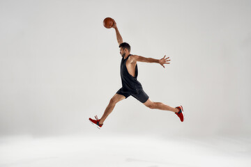 Fototapeta na wymiar Young caucasian basketball player leading ball