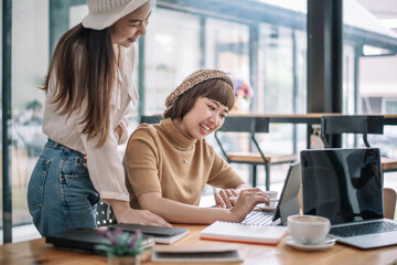 Two young asian businesswoman discussing new business projects during at office meeting.