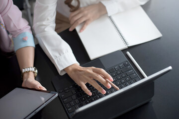 Close up. two businesswoman using digital tablet at meeting.