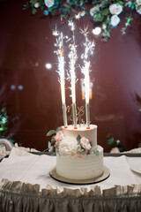 beautiful wedding cake on a table with lights