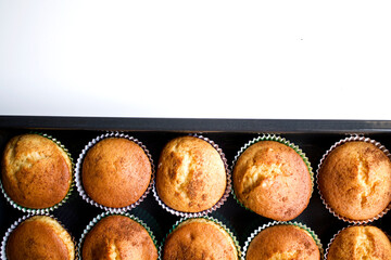 Half tray of fresh cupcakes and white background