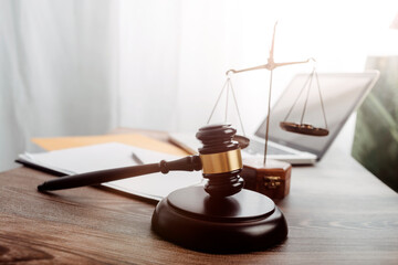 Business and lawyers discussing contract papers with brass scale on desk in office. Law, legal services, advice, justice and law concept picture with film grain effect