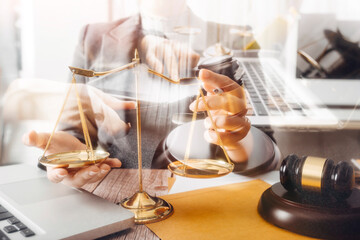 Justice and law concept.Male judge in a courtroom with the gavel, working with, computer and...