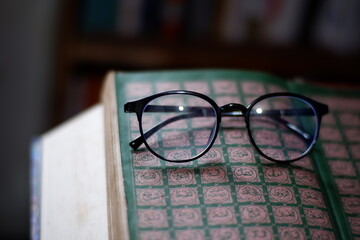 These glasses and thick books can be used as a background for computer screens, posters, banners, or calendars on the themes of literacy, spirituality, and science.