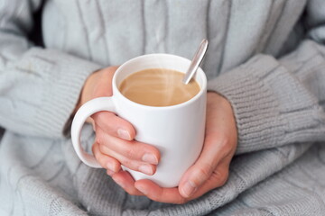Sipping hot cup of coffee on the couch