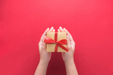 hand holding gift box with Merry Christmas and Happy New Year