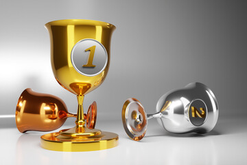 3d illustration of three gold, silver and bronze goblets on gray isolated background. Sports competition awards concept. Award symbols