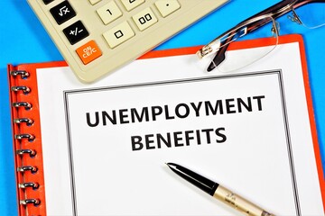 Unemployment benefit. Text label in the form on the folder. Compensation payments provided to employees who have lost their jobs.