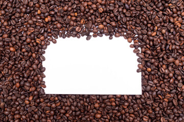 Pile of fresh aromatic coffee beans and paper mockup cup. Place for text or logo. Copy space.