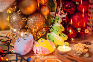 Handmade Christmas tree decorations on wooden table with many baubles on the background. Festive Christmas mood