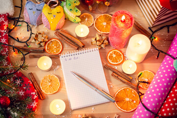 Decorated table with a notebook with inscription To do list in the middle. Concept of Christmas preparation, buying presents