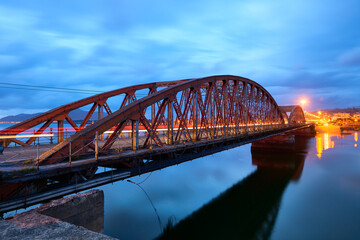 Fototapeta na wymiar Iron Bridge over the Ason river at evening, Colindres, Cantabria, Spain
