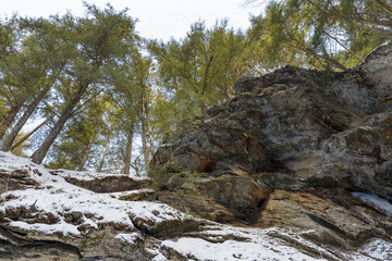 Moss Glen Falls in winter after snow storm. Water turned into ice and is covered with a snow. Bright sunny day.