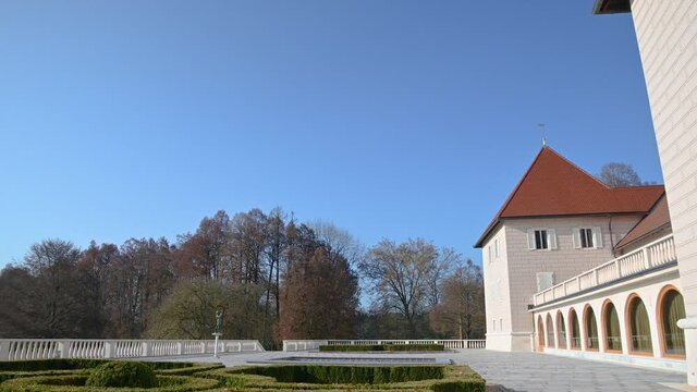 Beautiful old Brdo castle and courtyard in Brdo park, Slovenia, government venue for diplomatic meetings. Colorful autumn season on bright sunny day. Wide angle, tilt down