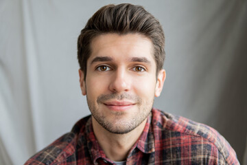 Portrait of a handsome latin guy with a cute face expression looking in to the camera isolated 