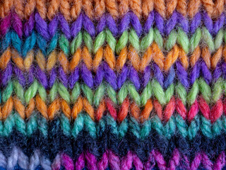 Fototapeta na wymiar brightly coloured hand knitting and wool background 