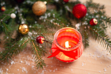 Candle near decorated Christmas tree. Christmas mood