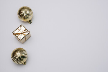 Golden Christmas balls on a white background. Minimalism. Free space for text