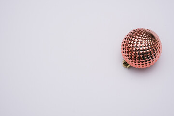 Pink Christmas balloon on a white background. Minimalism. Free space for text