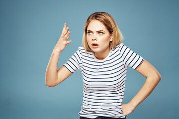 Upset woman emotions displeasure gestures with hands blue background