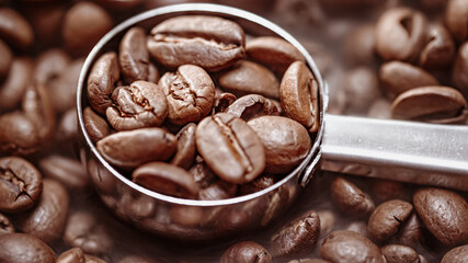 Close up of seeds of coffee. Fragrant coffee beans are roasted smoke comes from coffee beans.