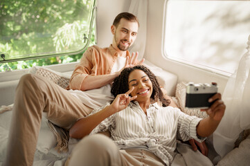 Couple makes selfie in rv bed, camping in trailer