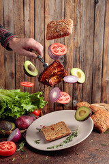 Grilled pork with rib on a fork.