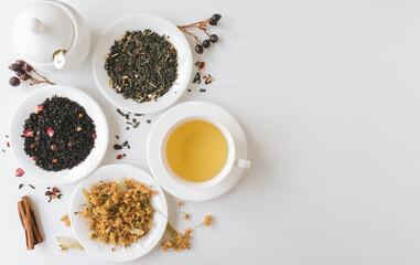 Tea composition on white wooden background with copy space. Tea preparation concept
