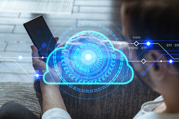 A man in casual wears, using smart phone. Double exposure. Cloud service hologram. Storage data concept.