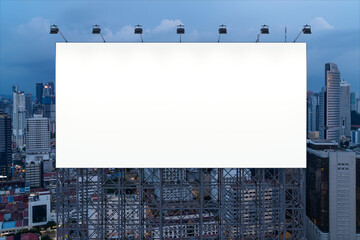 Blank white road billboard with KL cityscape background at night time. Street advertising poster, mock up, 3D rendering. Front view. The concept of marketing communication to promote or sell idea.