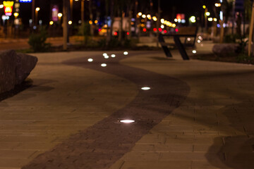 soft focus evening street walking site with lamp in ground tile illumination object