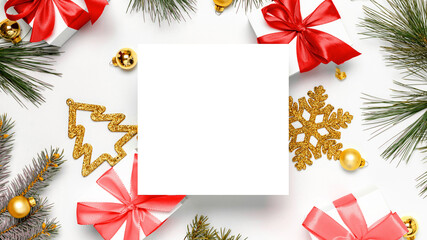 Christmas composition. White gift box with red ribbon, New Year balls and Christmas tree in xmas composition on white background for greeting card. Flat lay, top view, copy space.