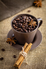 Fototapeta premium Brown Cup filled with coffee beans and cinnamon flavor.