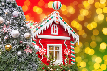Real christmas candy house on festive bokeh background. Festive greeting card with copy space.