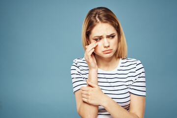 Upset woman emotions displeasure gestures with hands blue background