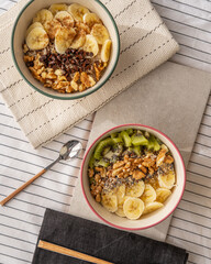 Top view of a porridge bowl with banana, kiwi, and a pear.