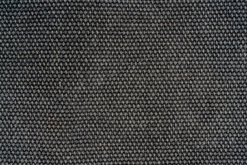 The texture of a dense gray woolen fabric. Close-up textile background.