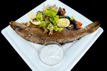 Whole fried trout with herbs and sauce