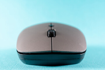 Wireless computer mouse on a blue background. Modern computer technologies.